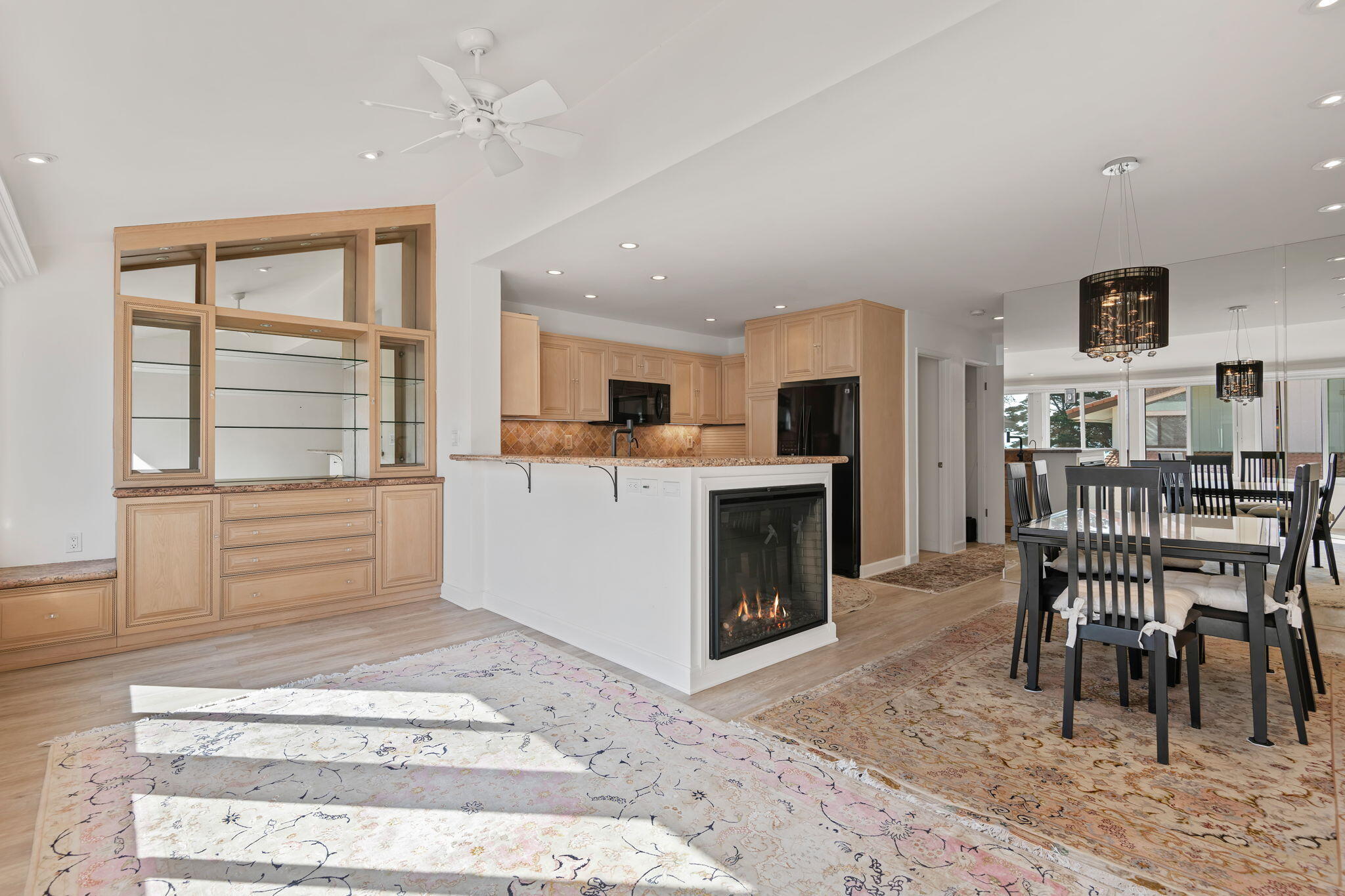 659 Del Parque Drive, Unit E Santa Barbara, CA 93103 - Photo 13 of 32 a living room with a dining table wooden floor and a fireplace