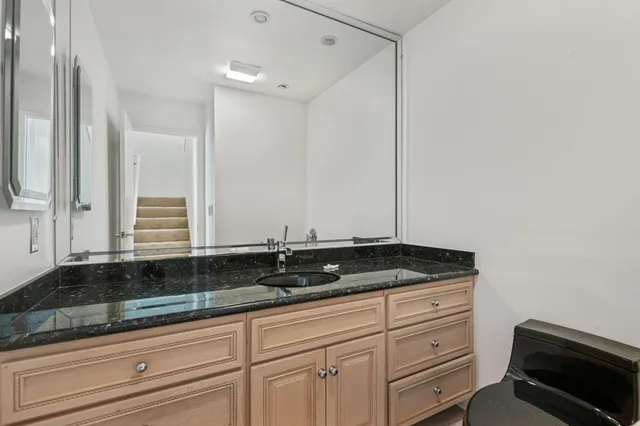 a bathroom with a shower sink and mirror