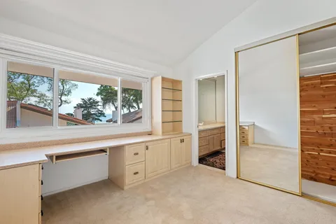 an empty room with window and cabinet
