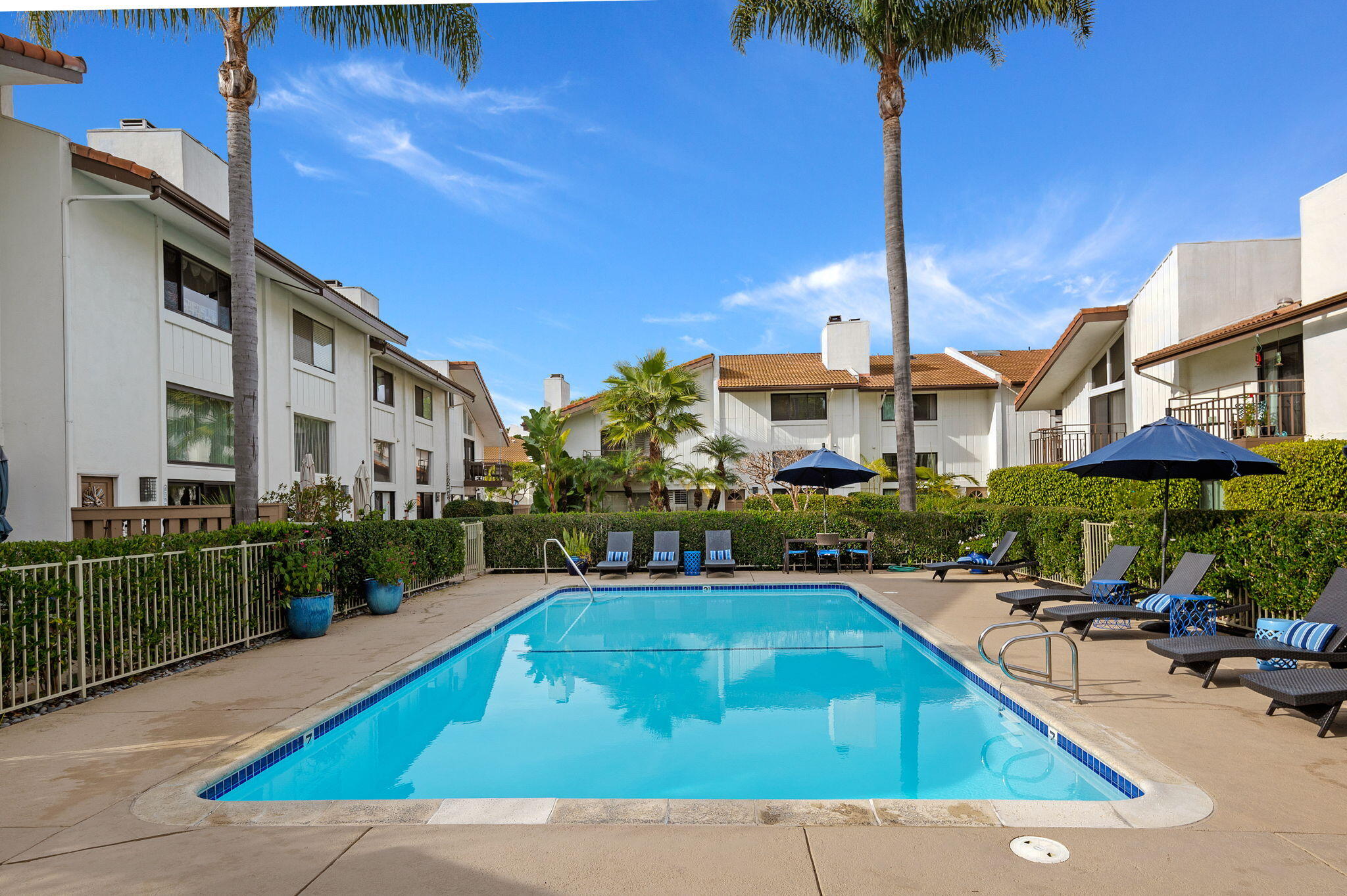 659 Del Parque Drive, Unit E Santa Barbara, CA 93103 - Photo 24 of 32 a view of a swimming pool with a lounge chairs