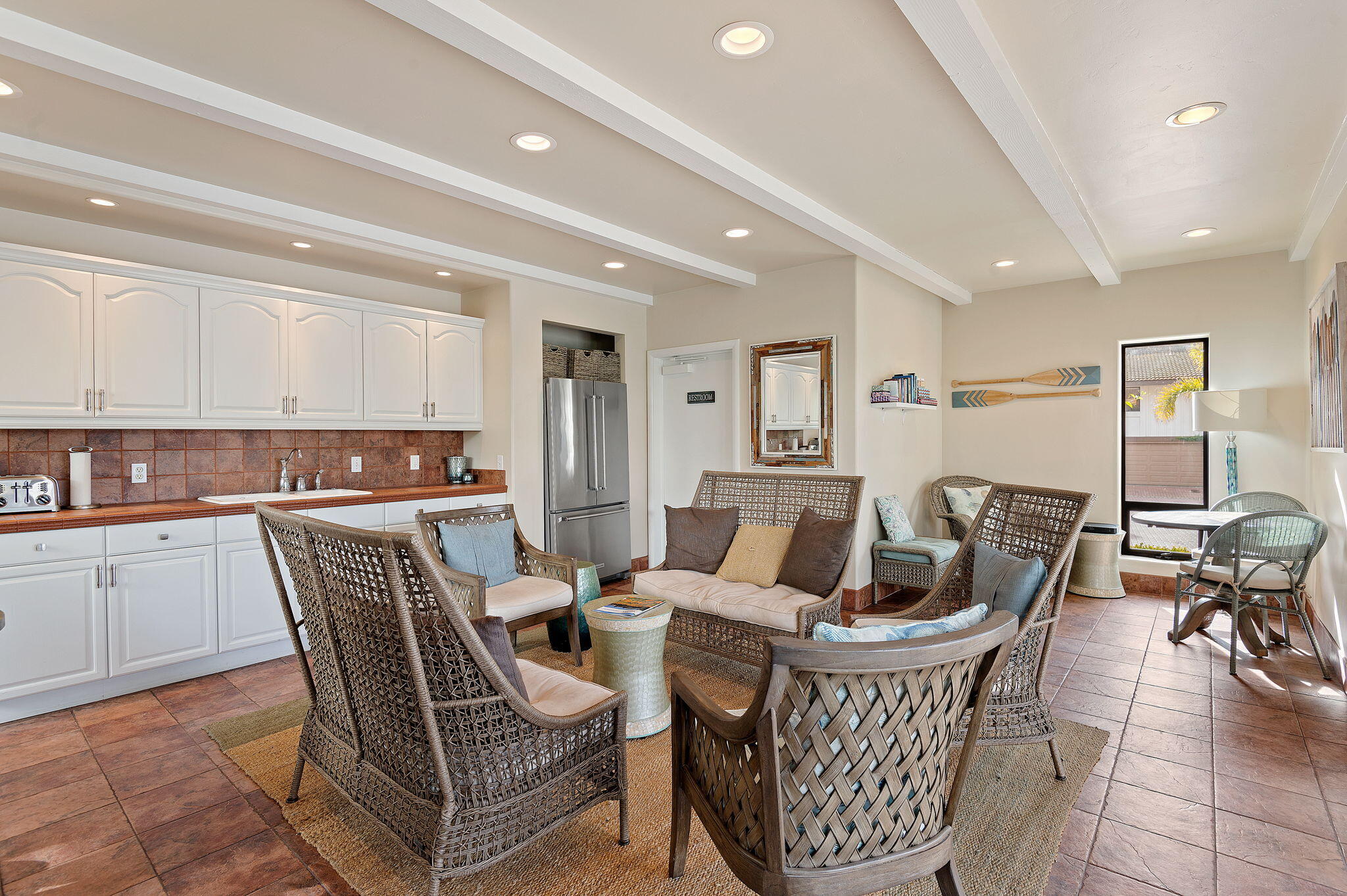 659 Del Parque Drive, Unit E Santa Barbara, CA 93103 - Photo 28 of 32 a living room with furniture a dining table and kitchen view