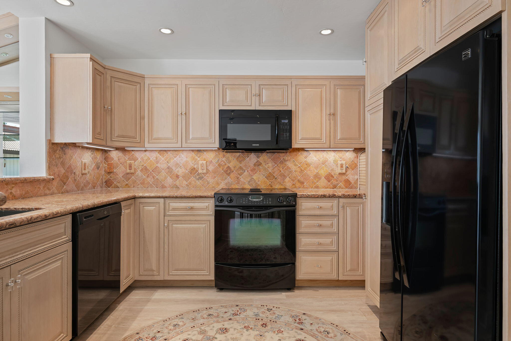 659 Del Parque Drive, Unit E Santa Barbara, CA 93103 - Photo 9 of 32 a kitchen with a stove and a refrigerator