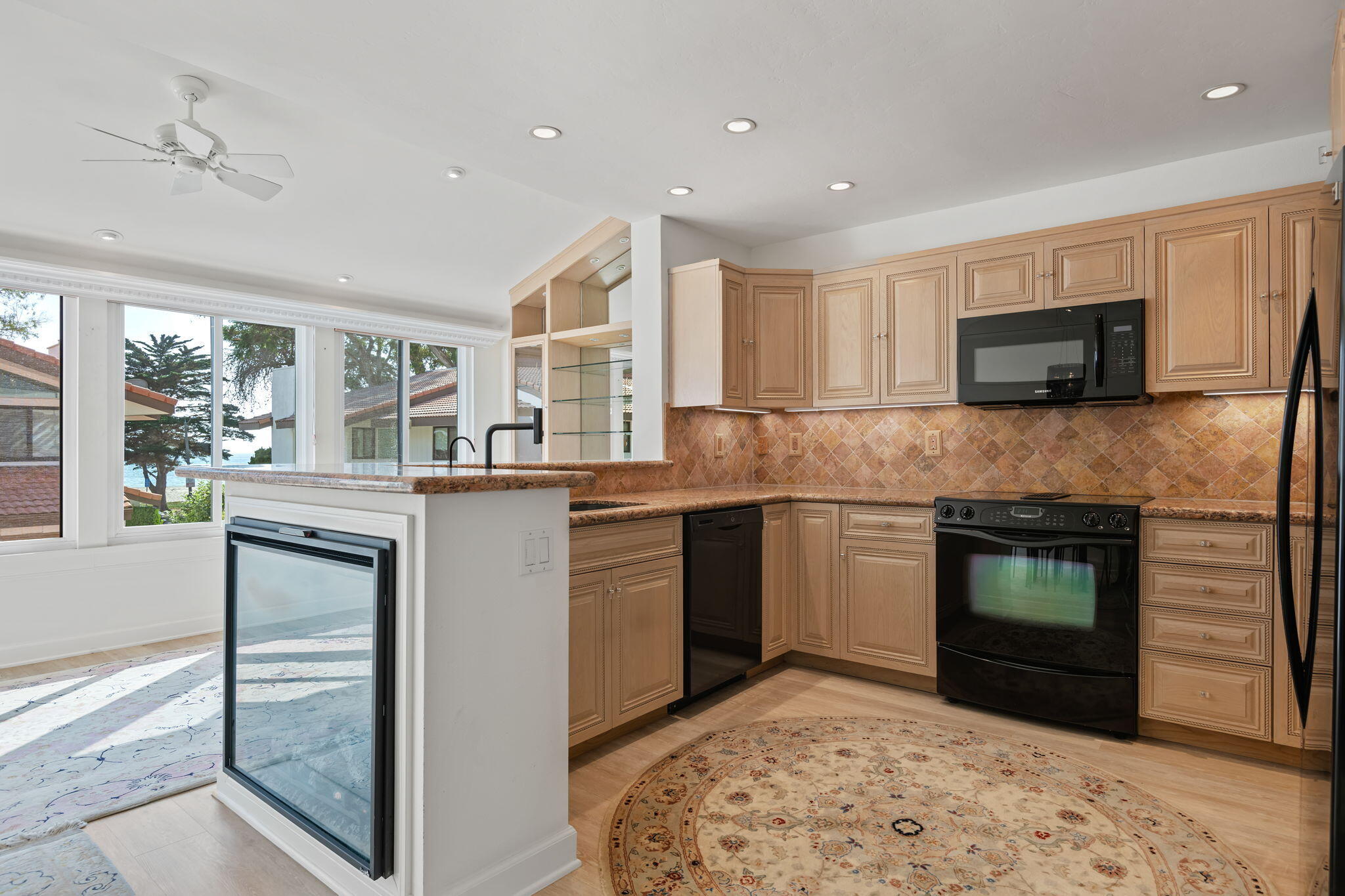659 Del Parque Drive, Unit E Santa Barbara, CA 93103 - Photo 10 of 32 a kitchen with stainless steel appliances granite countertop a stove a sink and a microwave