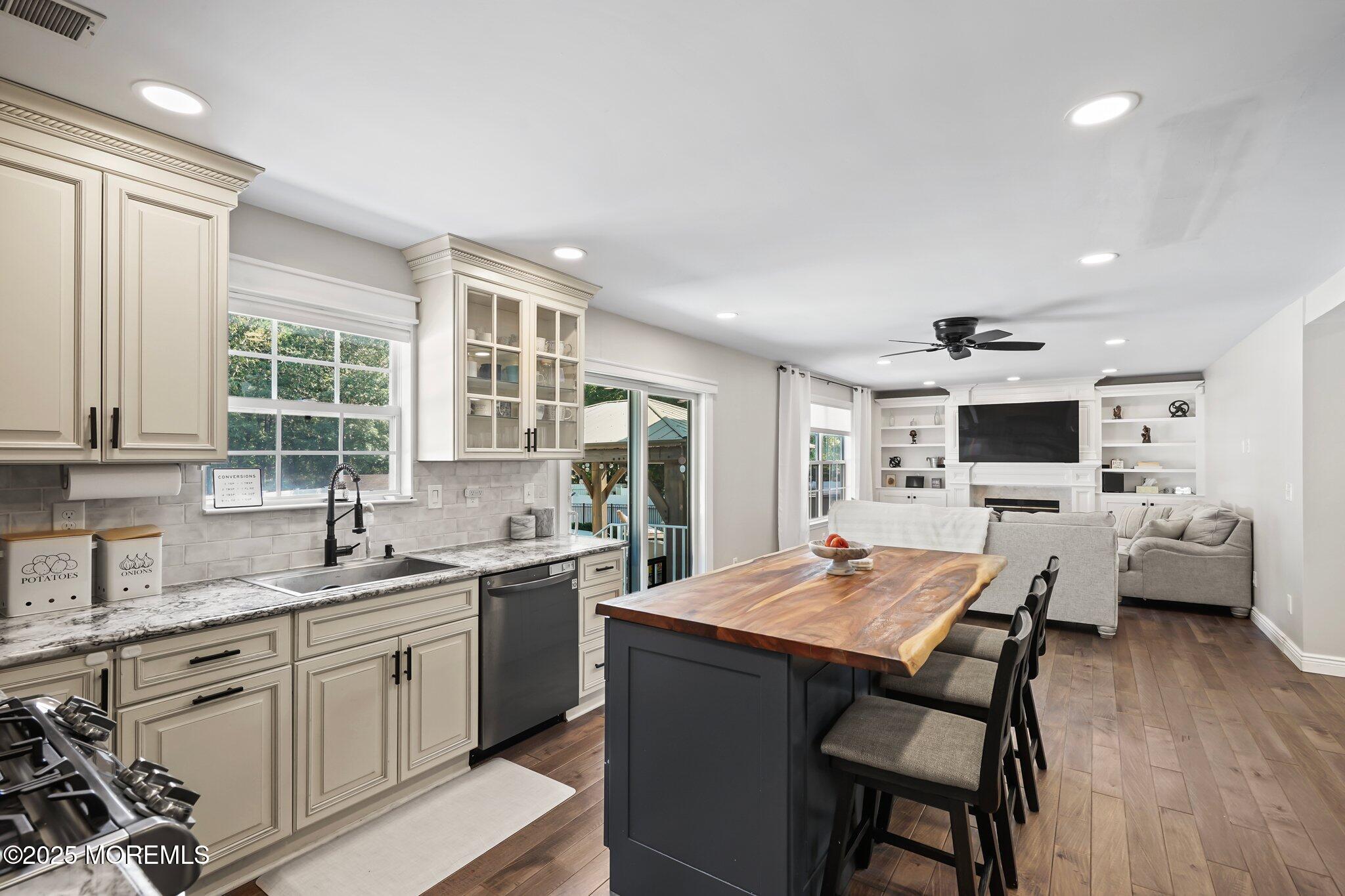24 Mount Ranier Drive Howell, NJ 07731 - Photo 12 of 53 a kitchen with a stove a sink dishwasher a dining table and chairs with wooden floor
