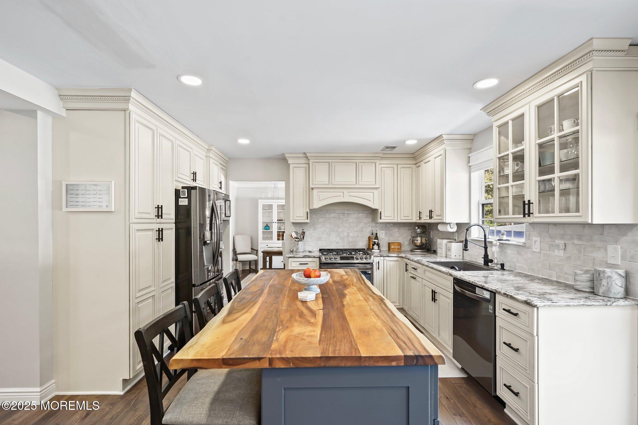 24 Mount Ranier Drive Howell, NJ 07731 - Photo 14 of 53 a large kitchen with stainless steel appliances granite countertop a sink a stove and refrigerator