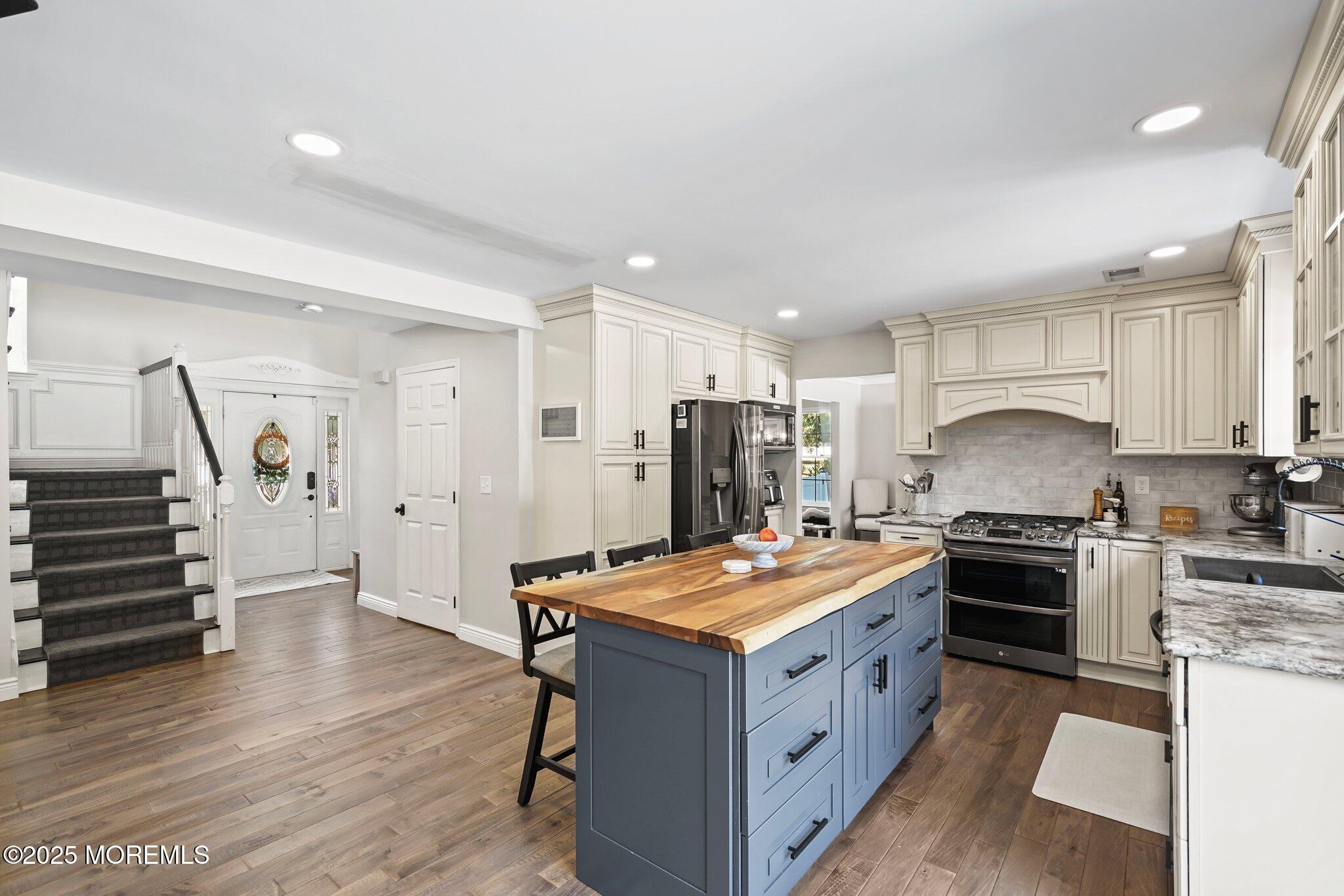 24 Mount Ranier Drive Howell, NJ 07731 - Photo 15 of 53 a kitchen with granite countertop a stove oven and a refrigerator