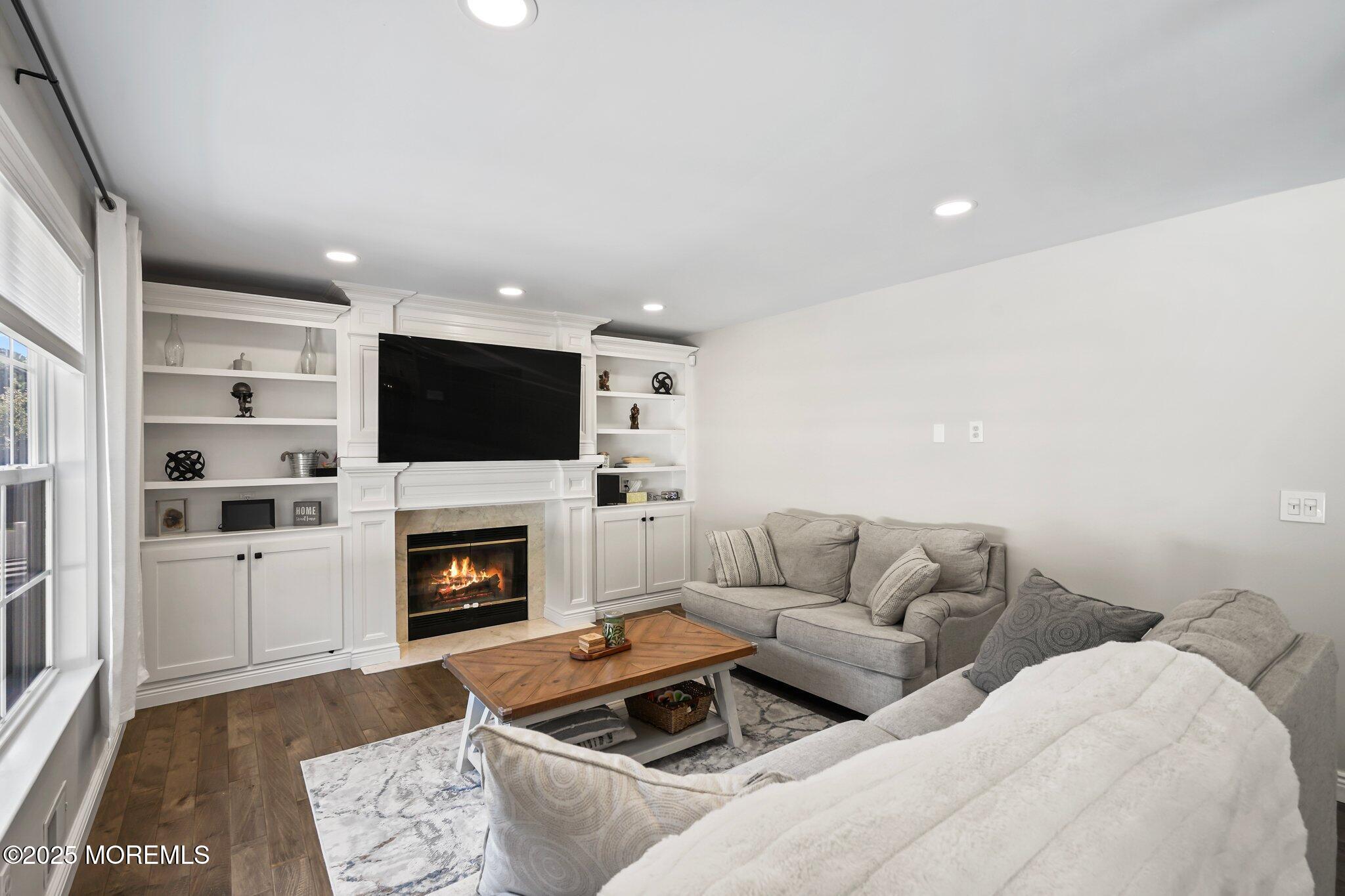24 Mount Ranier Drive Howell, NJ 07731 - Photo 16 of 53 a living room with furniture fireplace and flat screen tv