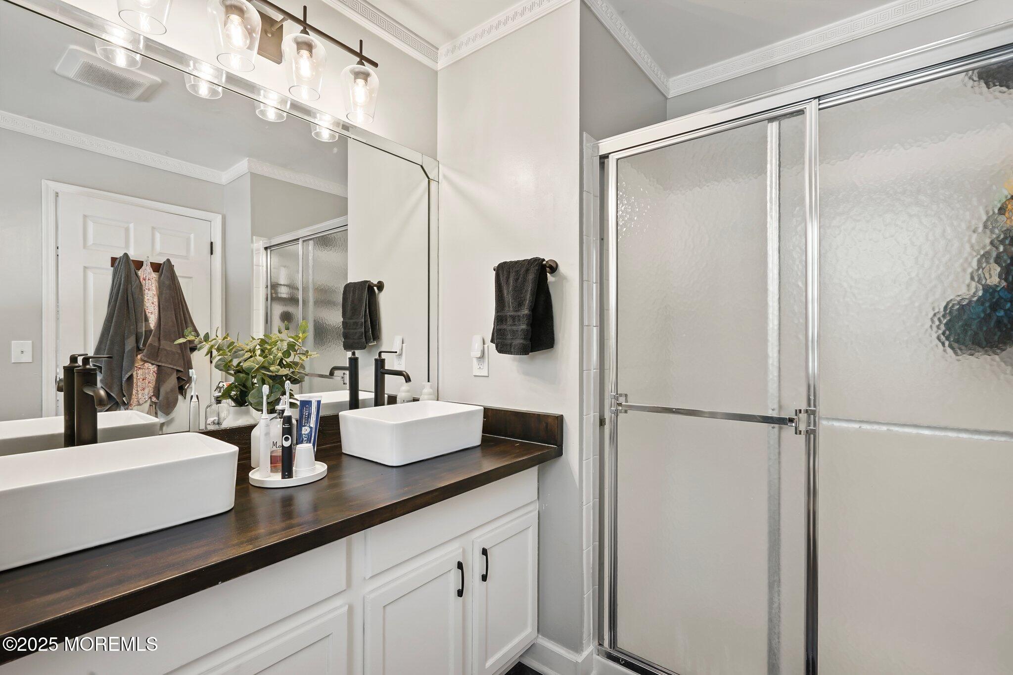 24 Mount Ranier Drive Howell, NJ 07731 - Photo 27 of 53 a bathroom with a double vanity sink a mirror and shower
