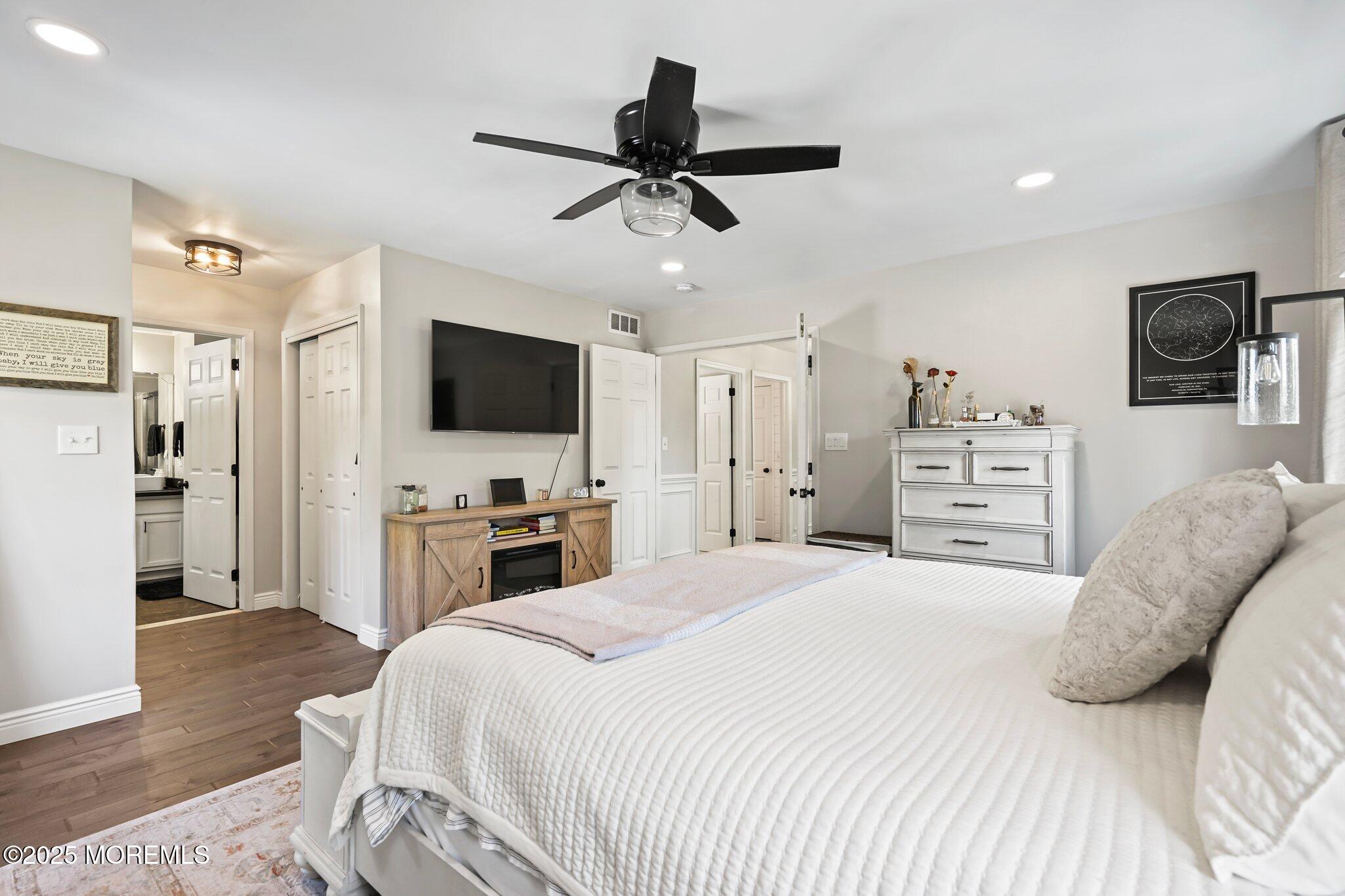 24 Mount Ranier Drive Howell, NJ 07731 - Photo 29 of 53 a bedroom with a bed flat screen tv and a couch