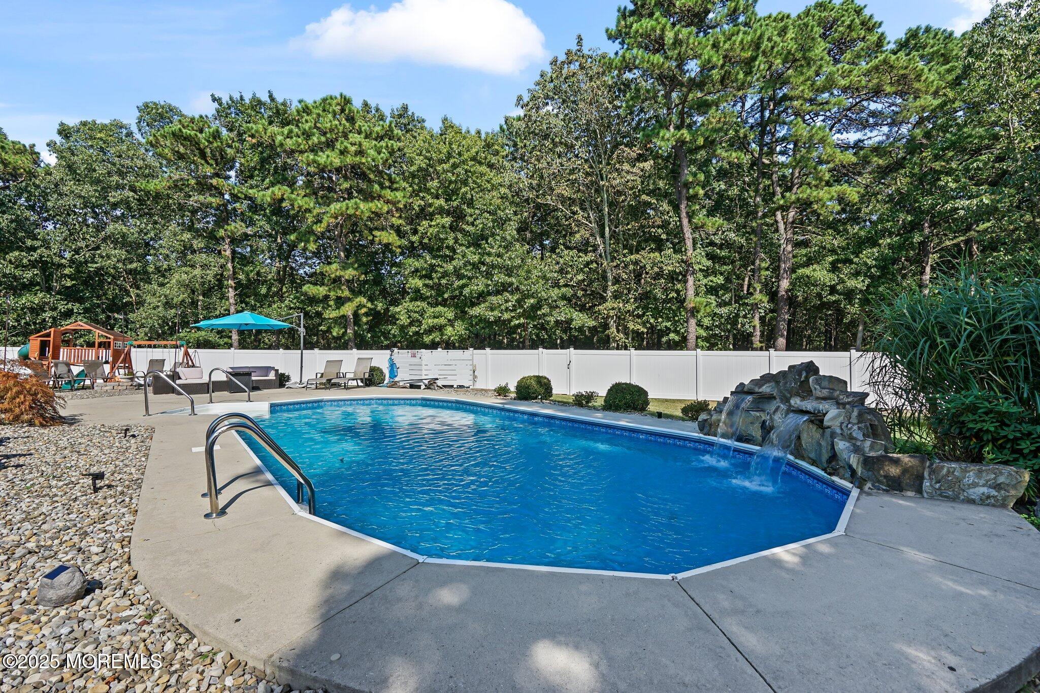 24 Mount Ranier Drive Howell, NJ 07731 - Photo 42 of 53 a view of a swimming pool with a yard