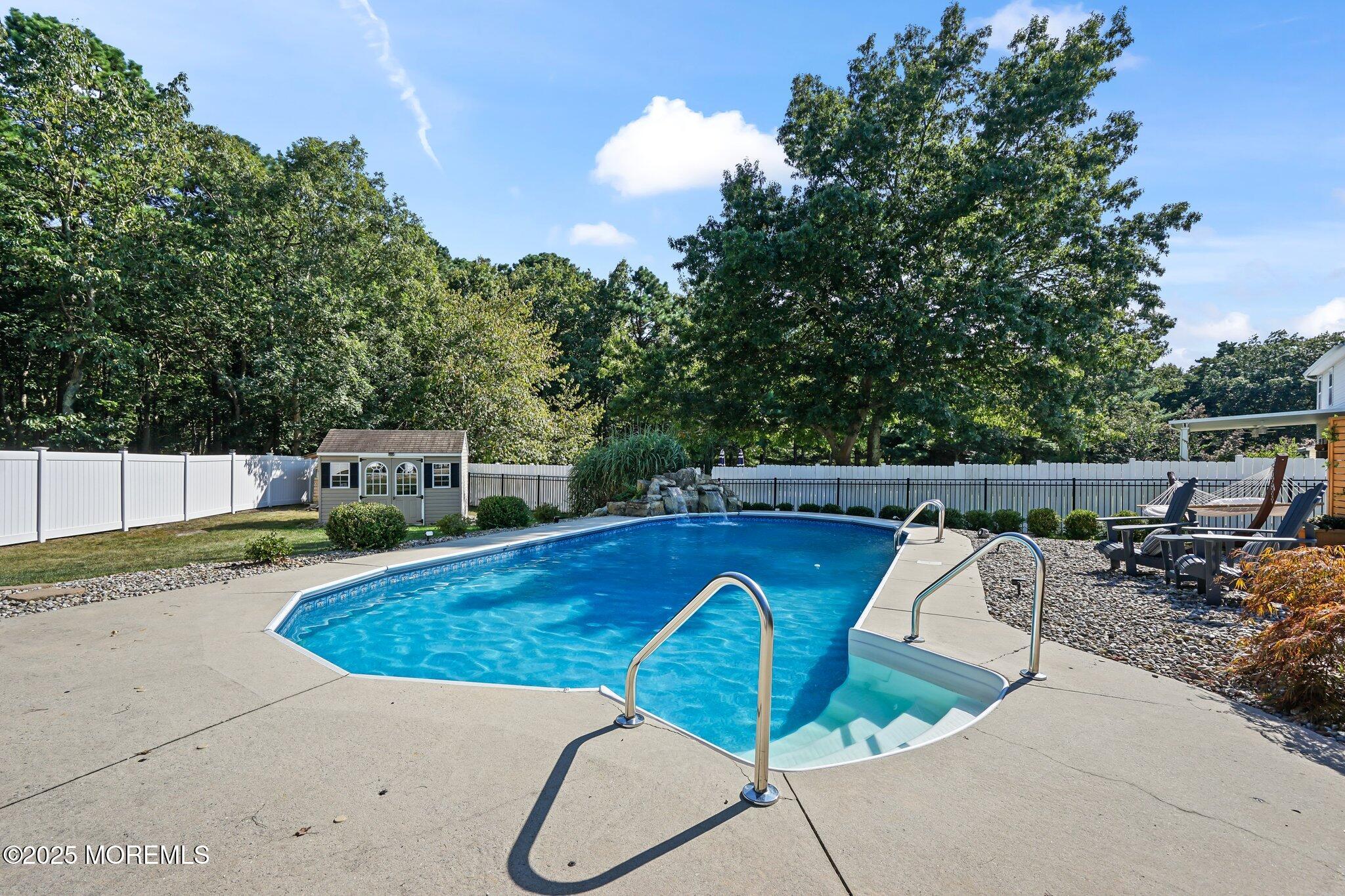 24 Mount Ranier Drive Howell, NJ 07731 - Photo 43 of 53 a view of a swimming pool with a patio