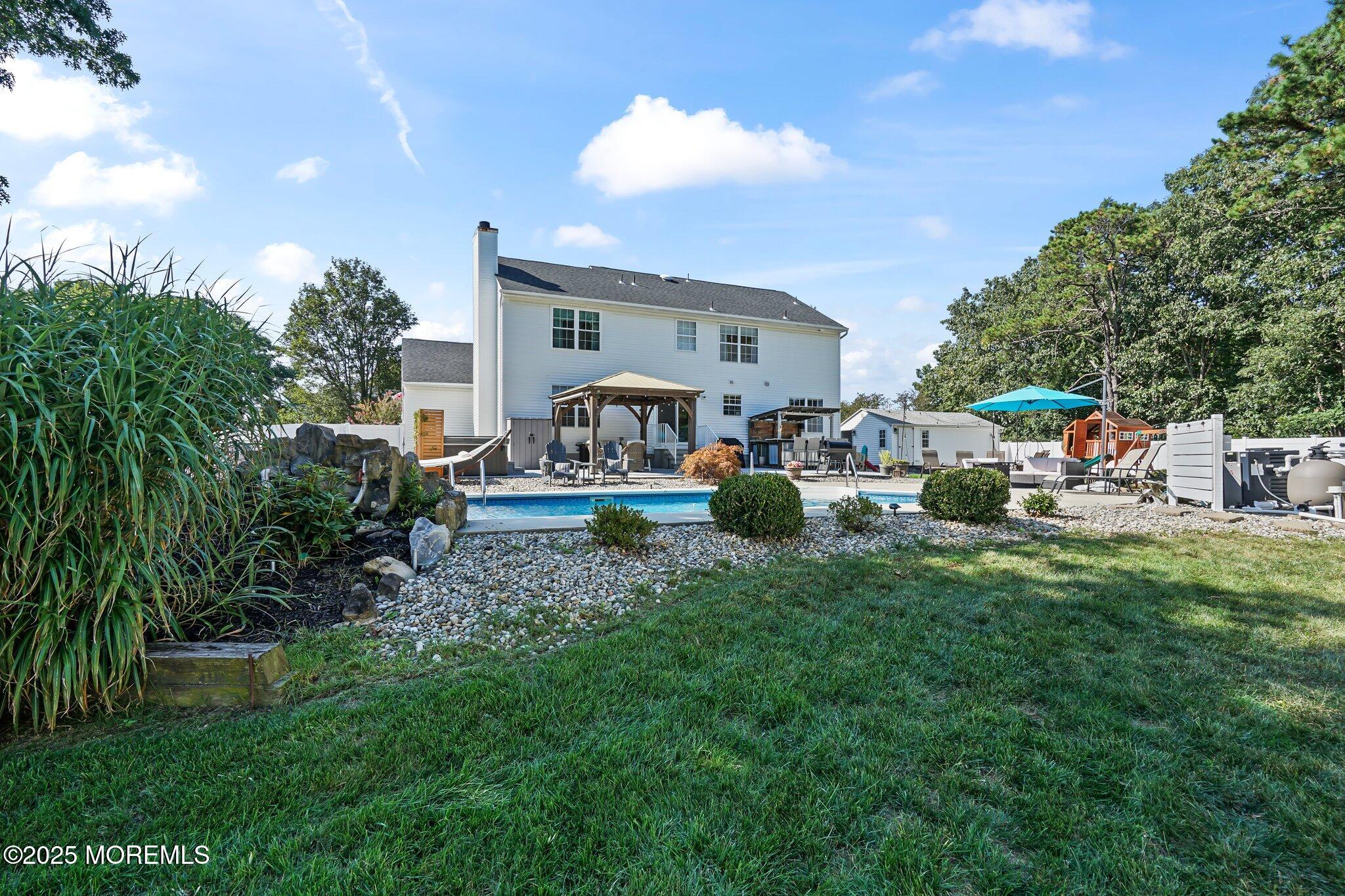 24 Mount Ranier Drive Howell, NJ 07731 - Photo 46 of 53 a front view of a house with a garden and outdoor seating