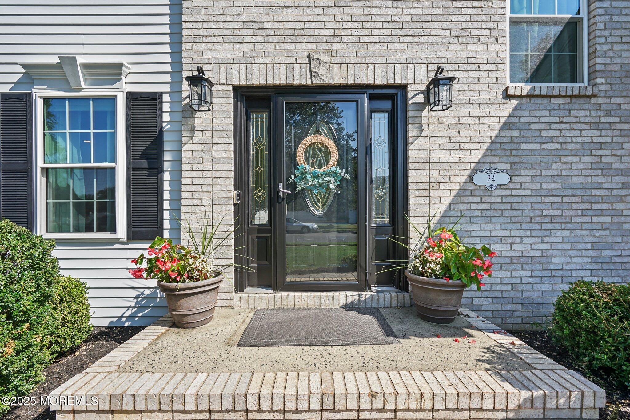 24 Mount Ranier Drive Howell, NJ 07731 - Photo 5 of 53 a couple of flower plants in front of door