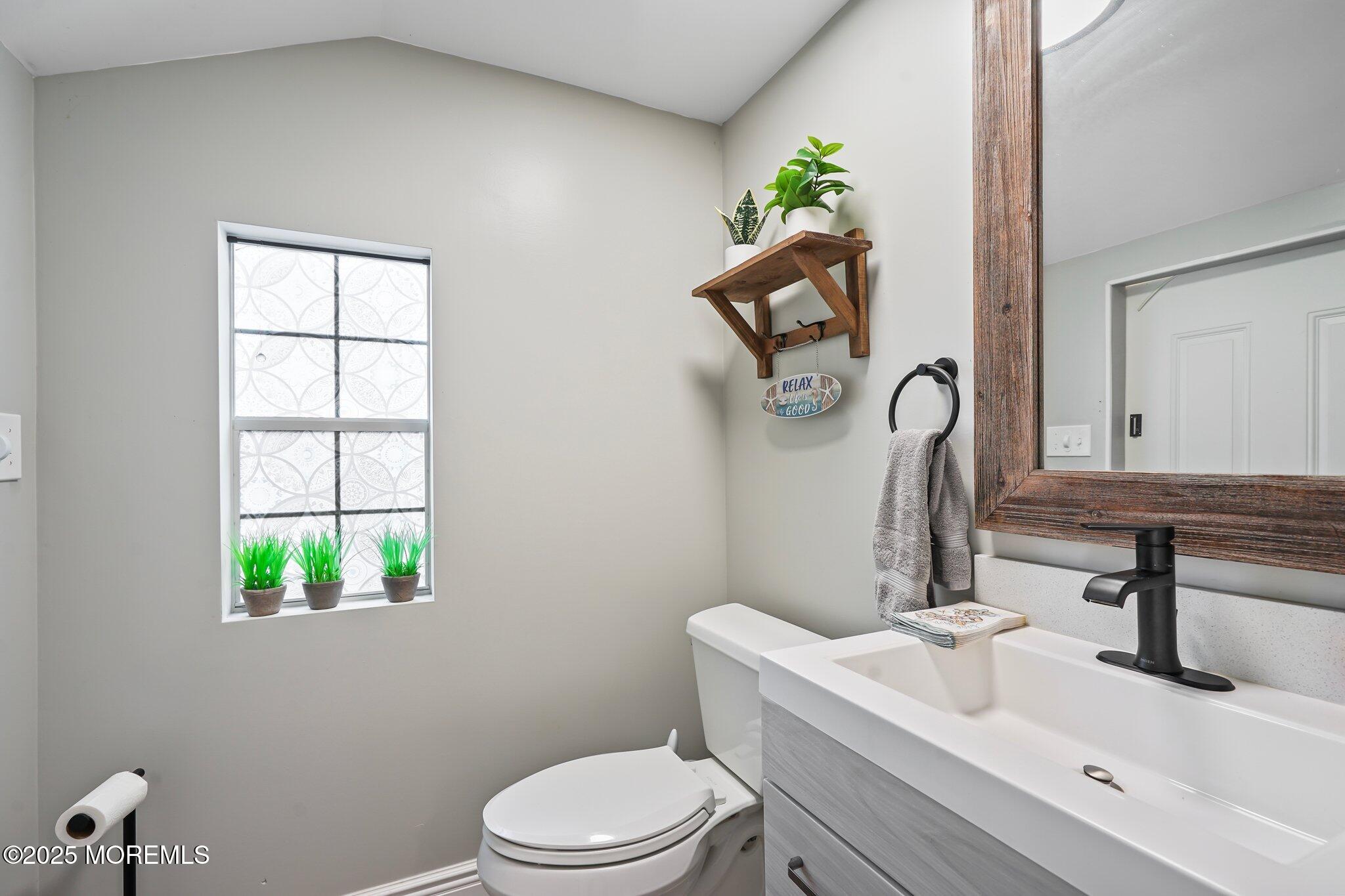 24 Mount Ranier Drive Howell, NJ 07731 - Photo 51 of 53 a bathroom with a toilet sink and mirror