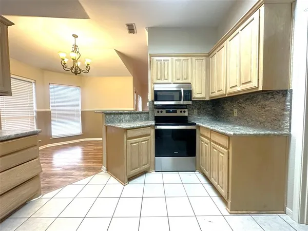 a kitchen with a stove a sink and a refrigerator