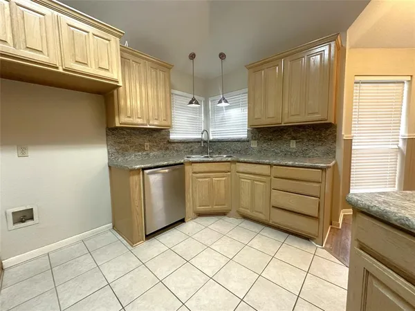 a kitchen with stainless steel appliances granite countertop a sink and cabinets