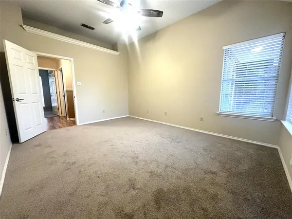 an empty room with windows and entrance