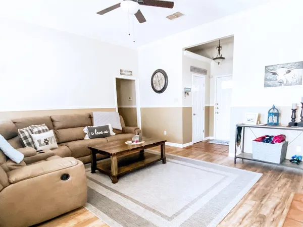 a living room with furniture and a rug