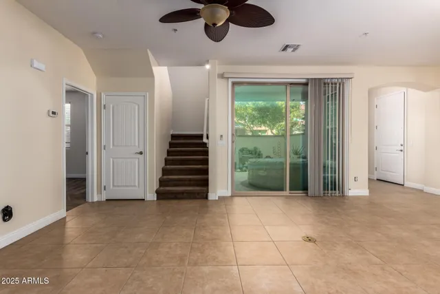 a large kitchen with kitchen island granite countertop a stove a sink a counter space and cabinets