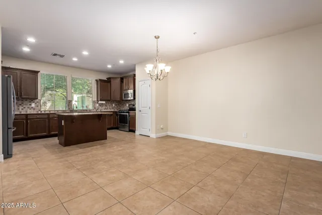 a kitchen with a sink stove top oven and refrigerator