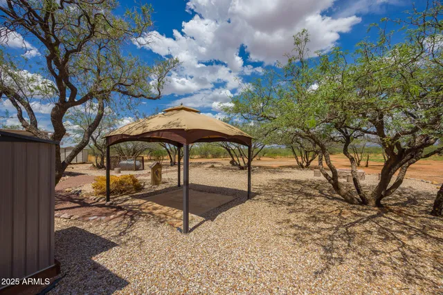 a table and chairs in the backyard of the house