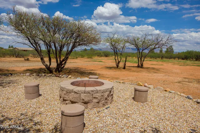 a view of a backyard of a house with table and chairs