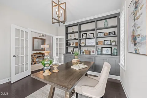 a dining room with furniture and wooden floor