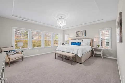 a spacious bedroom with a bed couch and a window