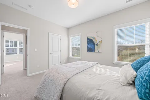 a bedroom with a large bed and a window