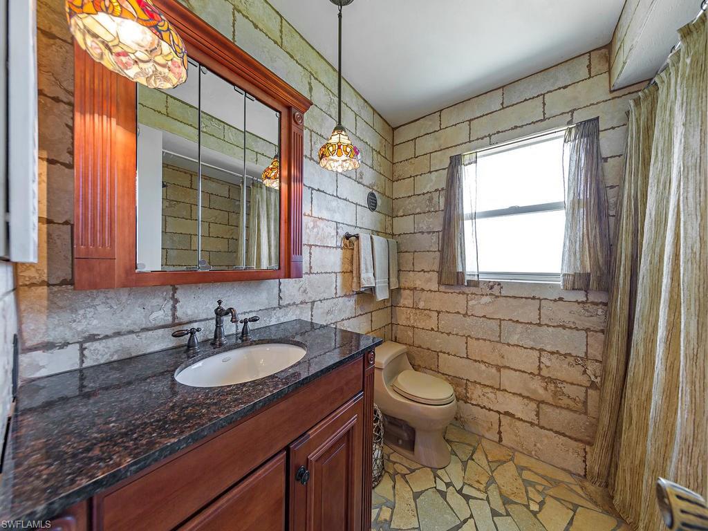 3065 50th Lane Southwest Naples, FL 34116 - Photo 4 of 25 a bathroom with a granite countertop sink toilet and shower