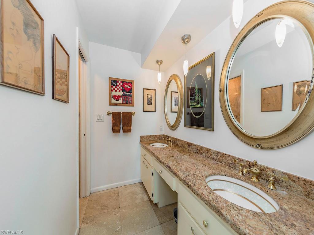 3065 50th Lane Southwest Naples, FL 34116 - Photo 5 of 25 a bathroom with a granite countertop double vanity sink and a mirror