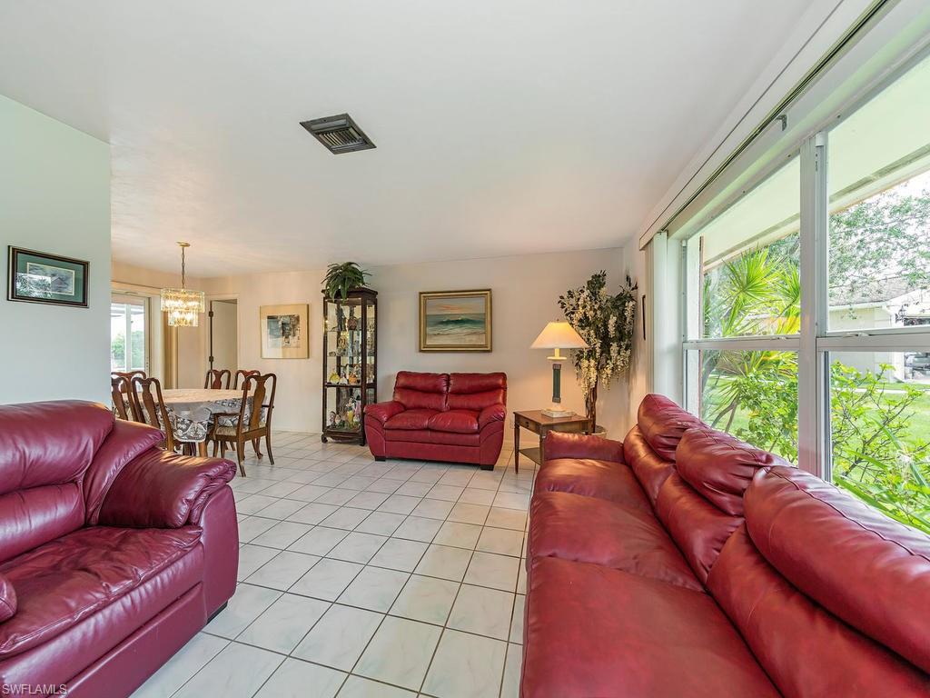 3065 50th Lane Southwest Naples, FL 34116 - Photo 8 of 25 a living room with furniture and large windows