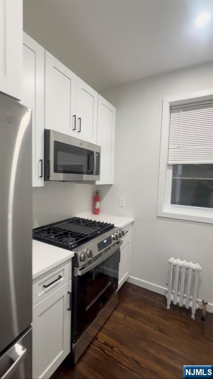 207 Valley Road, Unit 7 Clifton, NJ 07013 - Photo 4 of 8 a kitchen with granite countertop wooden cabinets and stainless steel appliances