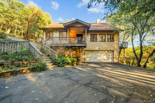 a front view of a house with a yard and outdoor space