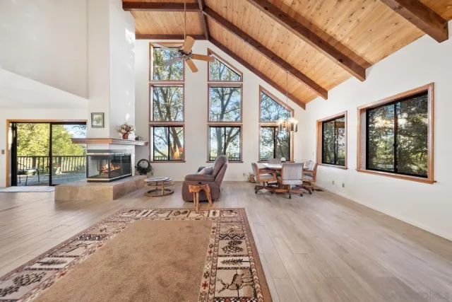 a living room with furniture large window and chairs