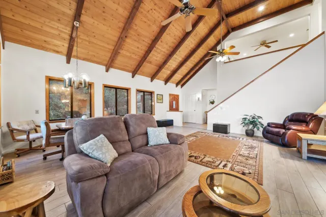 a living room with furniture a rug and white walls