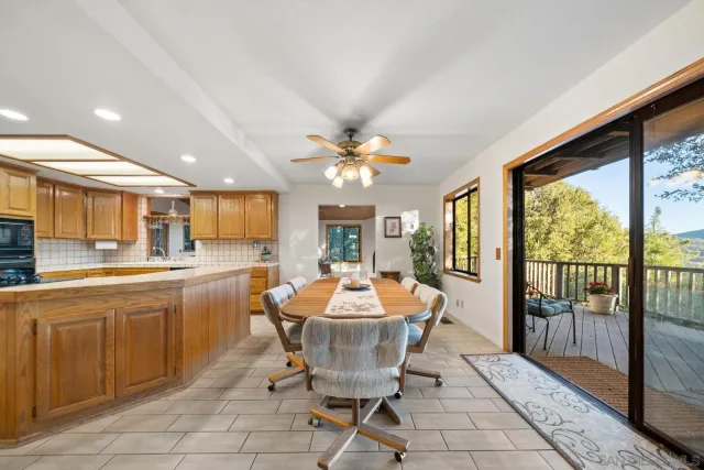 a dining room with furniture a chandelier and window