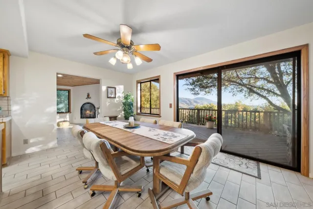 a dining room with furniture a rug and a large window