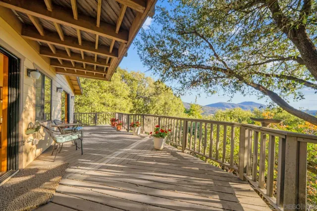 a view of a balcony with wooden floor and outdoor space