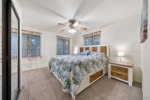 a spacious bathroom with a granite countertop sink mirror and bathtub