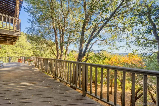 a view of a balcony with wooden floor