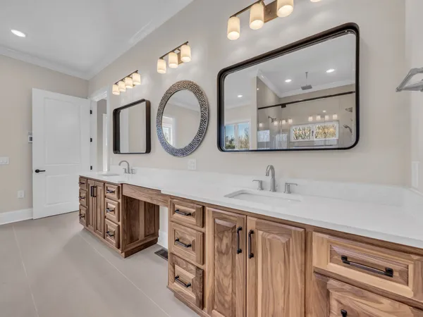 a bathroom with a double vanity sink a mirror and a bathtub