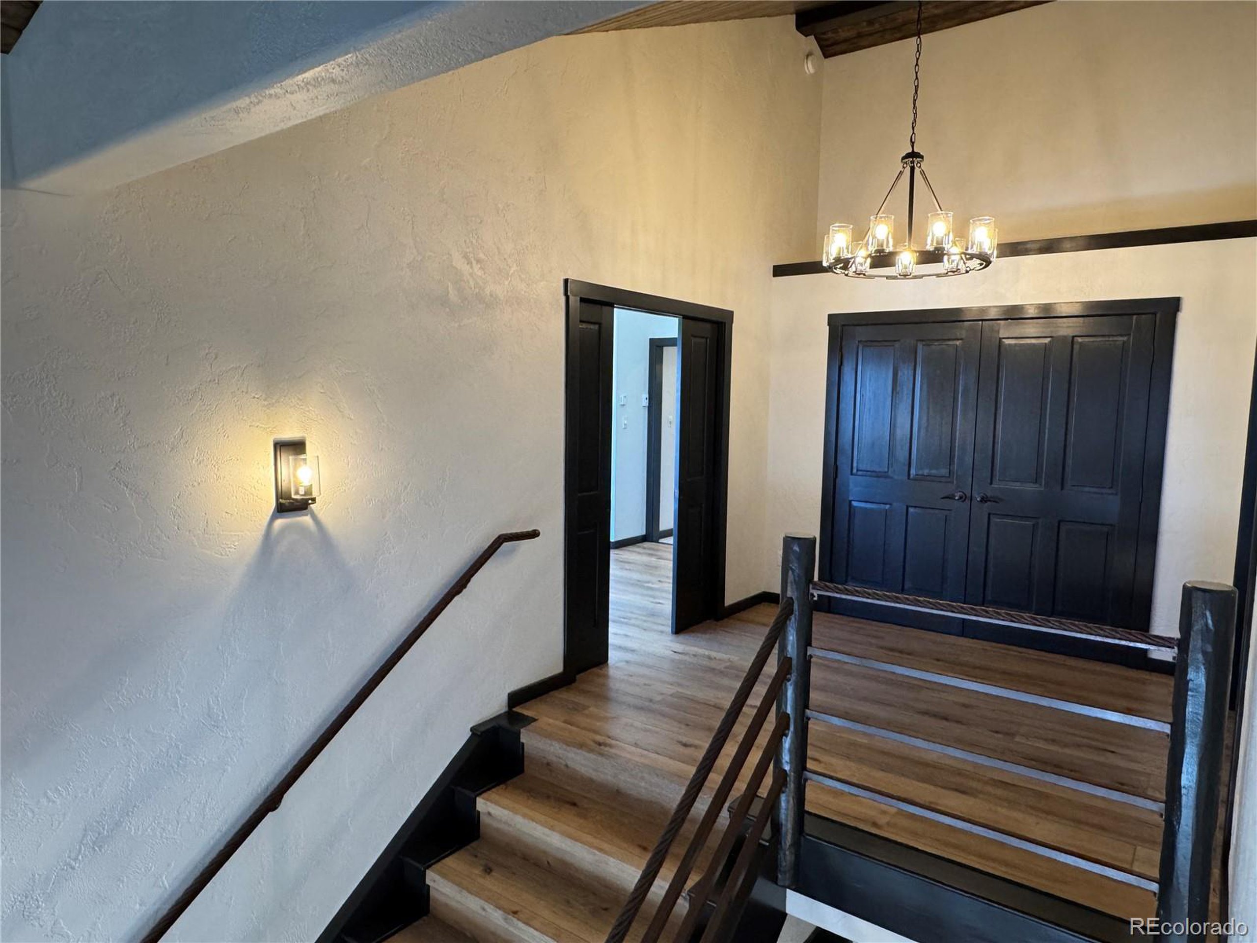 680 Ridge Road Westcliffe, CO 81252 - Photo 15 of 46 a view of a hallway with furniture and chandelier