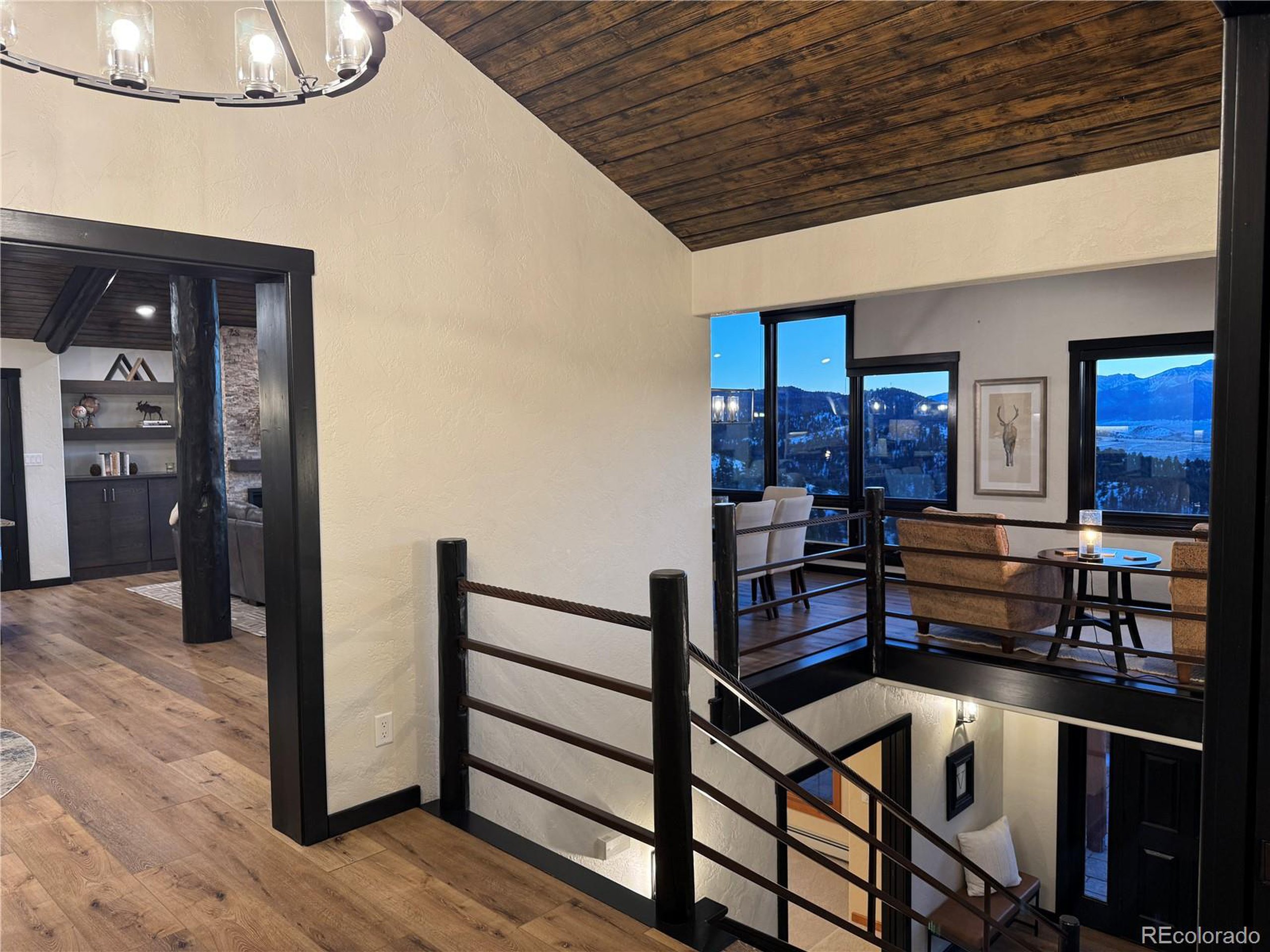 680 Ridge Road Westcliffe, CO 81252 - Photo 16 of 46 a view of a hallway with wooden floor and staircase