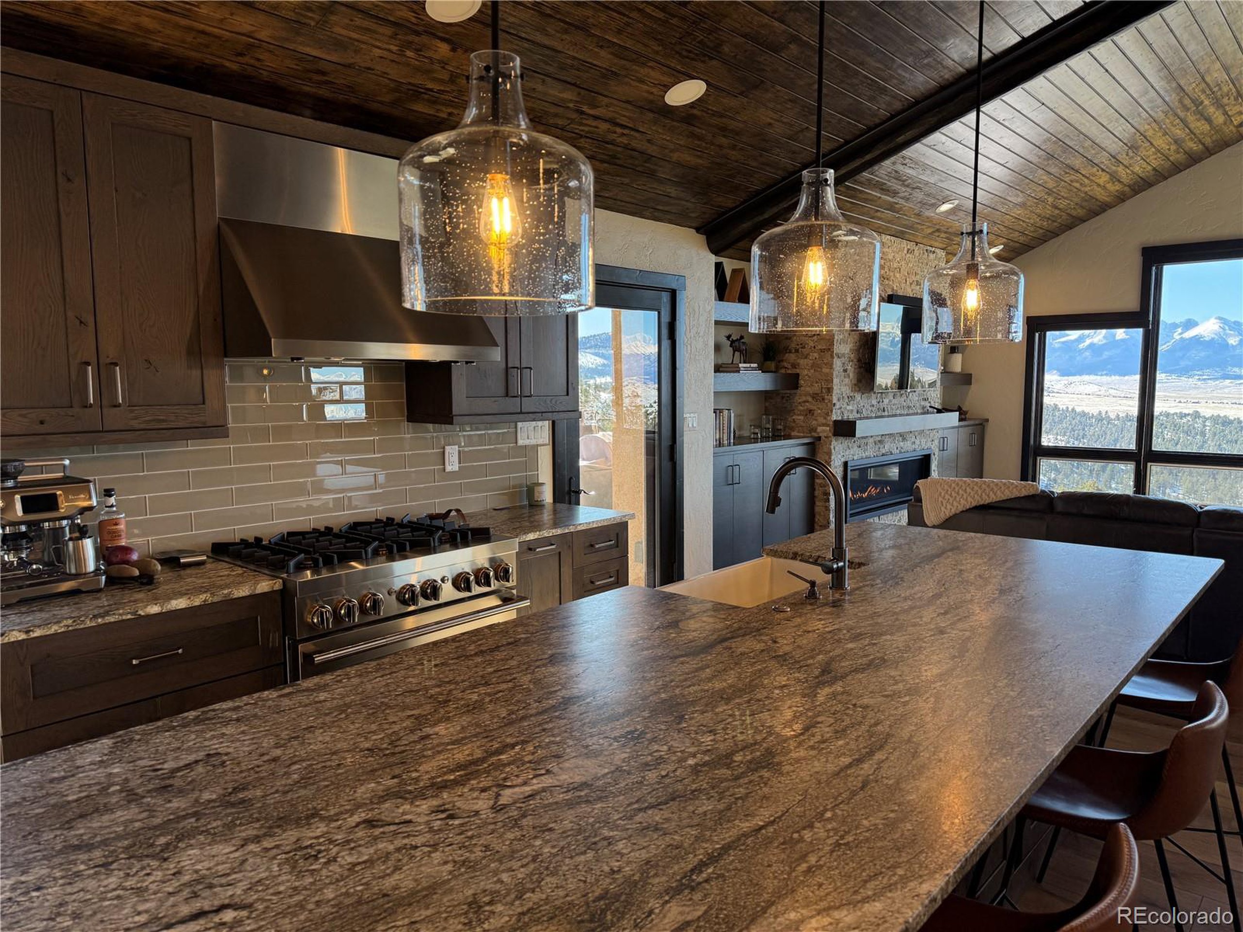 680 Ridge Road Westcliffe, CO 81252 - Photo 23 of 46 a kitchen with stainless steel appliances granite countertop a stove and a refrigerator