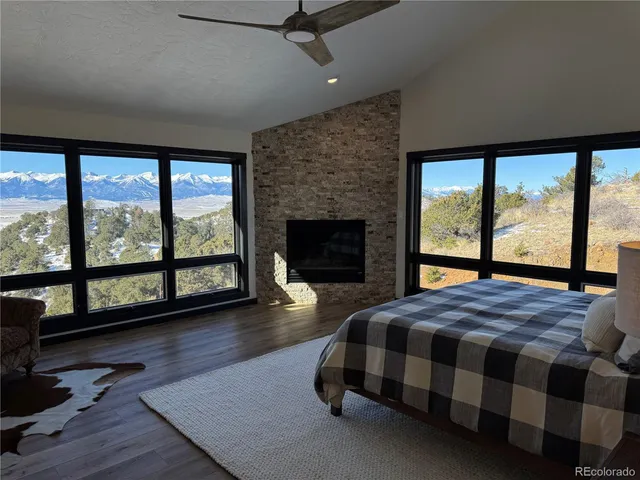 a bedroom with a bed and a large window