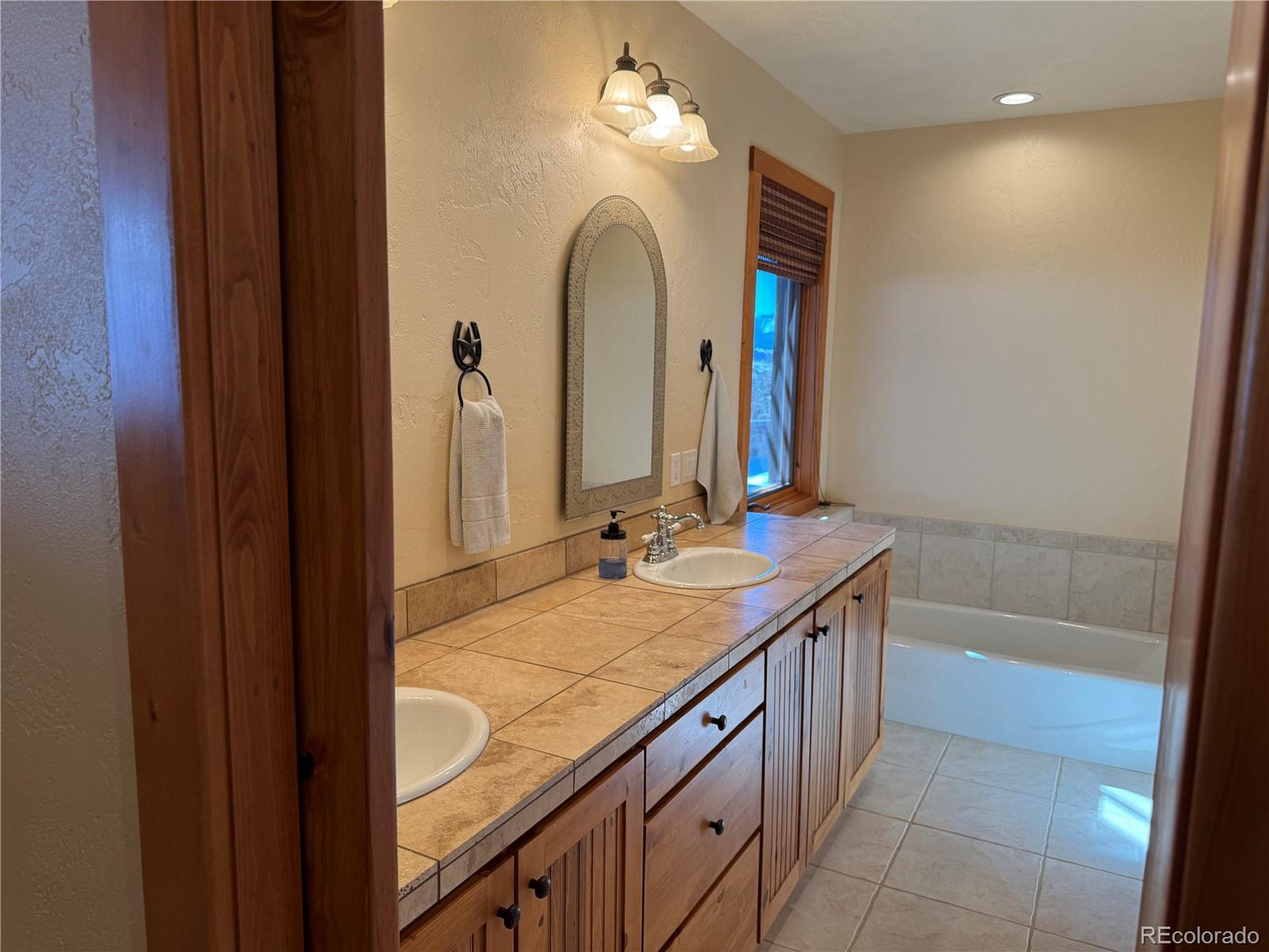 680 Ridge Road Westcliffe, CO 81252 - Photo 38 of 46 a bathroom with a granite countertop sink a toilet and a mirror