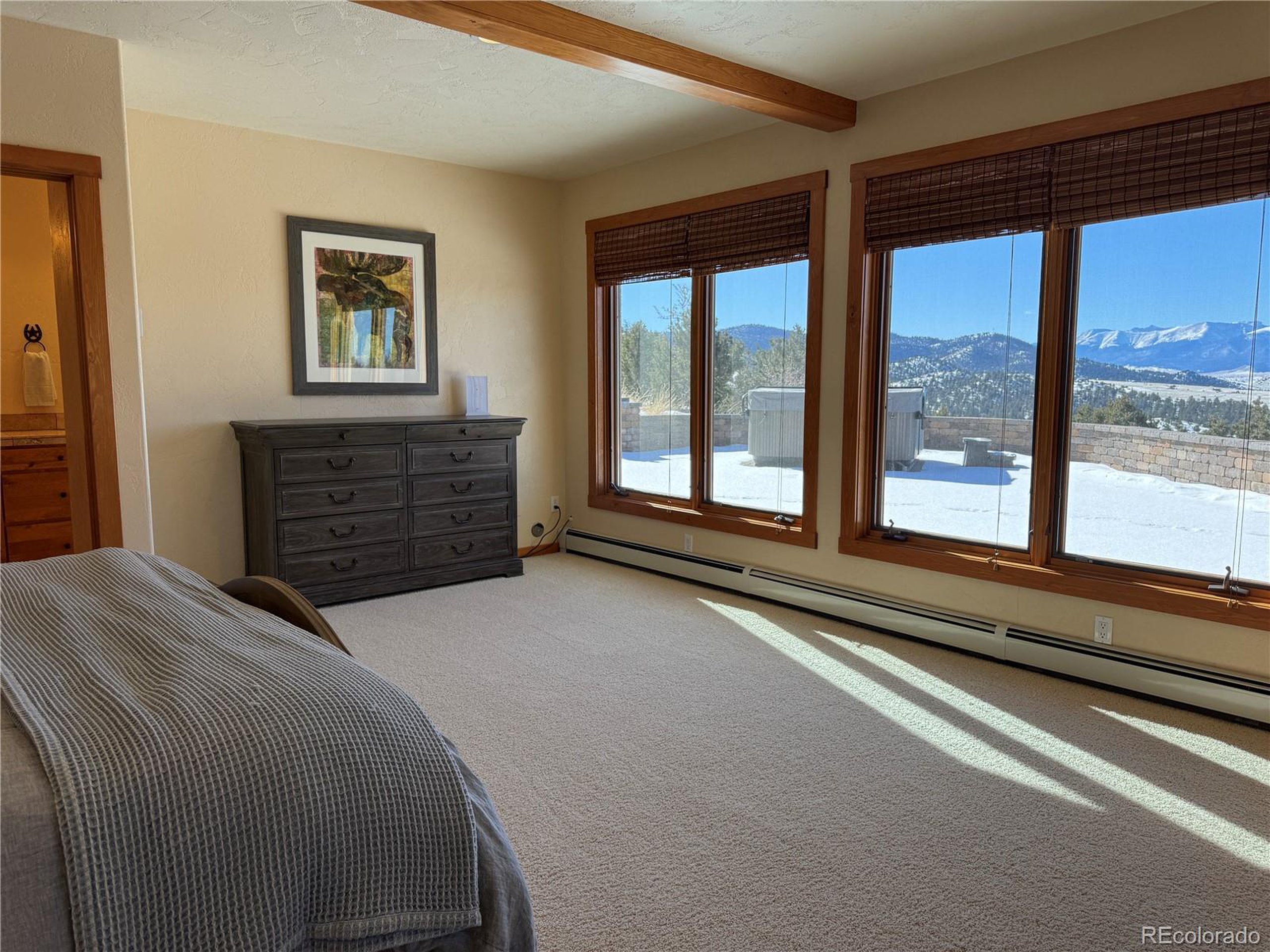 680 Ridge Road Westcliffe, CO 81252 - Photo 39 of 46 a bedroom with a bed and a large window