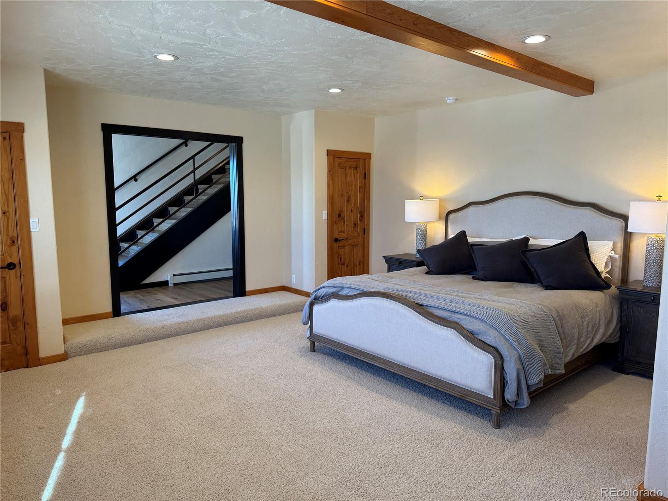 680 Ridge Road Westcliffe, CO 81252 - Photo 40 of 46 a bedroom with a bed and a painting on the wall