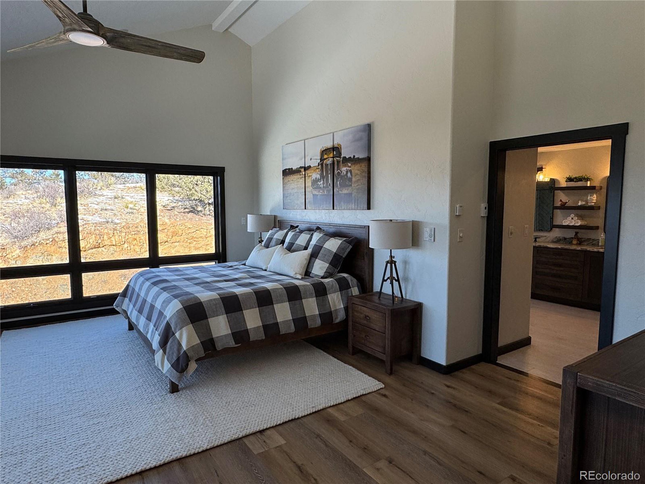 680 Ridge Road Westcliffe, CO 81252 - Photo 4 of 46 a bedroom with a bed and wooden floor